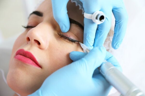 Cosmetologist Applying Permanent Make Up On Eyes, Close Up